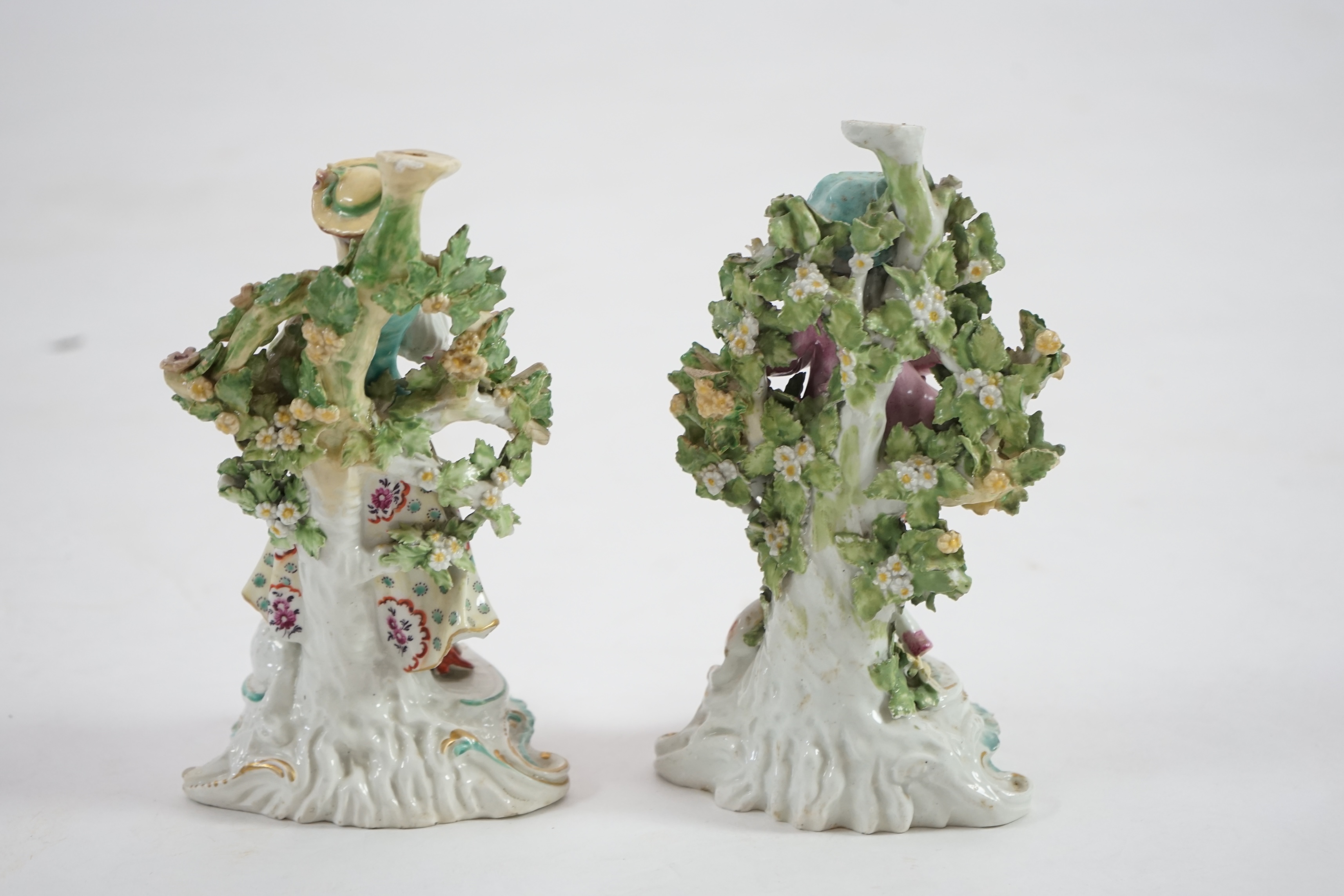 A pair of Derby candlestick groups of a shepherd and shepherdess, c.1775